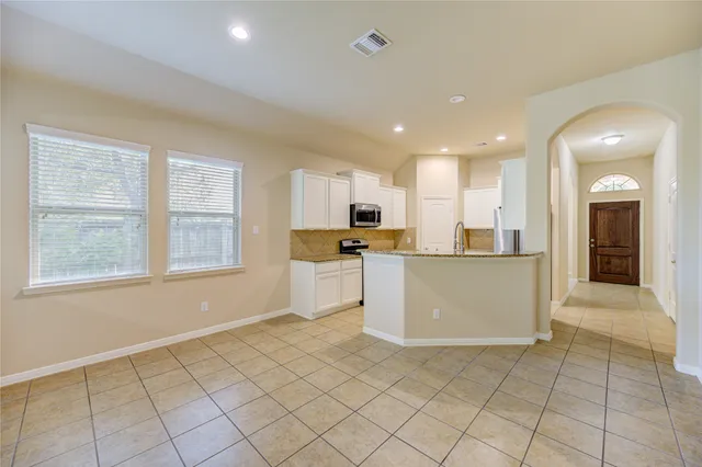 a view of a kitchen with microwave and cabinets