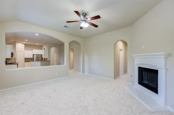 a view of an empty room with a fireplace