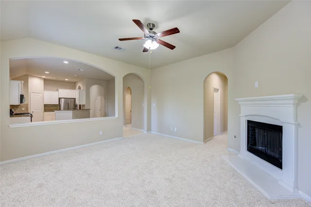 a view of an empty room with a fireplace