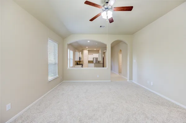 en empty room with window and ceiling fan