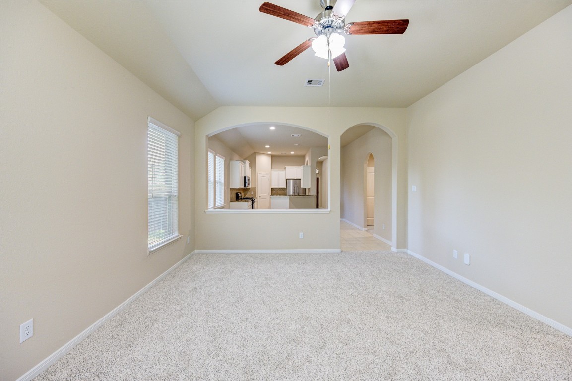 19306 Boulder Bay Lane Humble, TX 77346 - Photo 18 of 46 an empty room with chandelier fan and windows