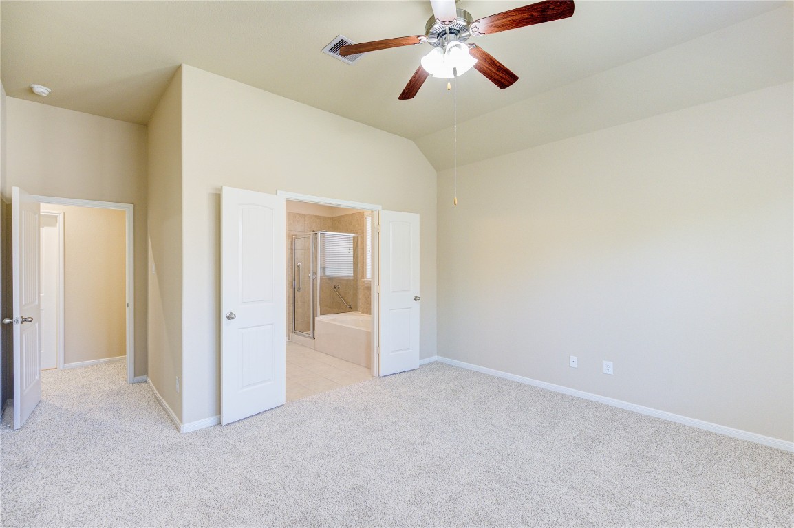 19306 Boulder Bay Lane Humble, TX 77346 - Photo 20 of 46 en empty room with closet and a chandelier fan