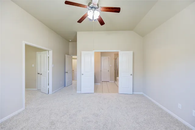 a view of empty room with ceiling fan