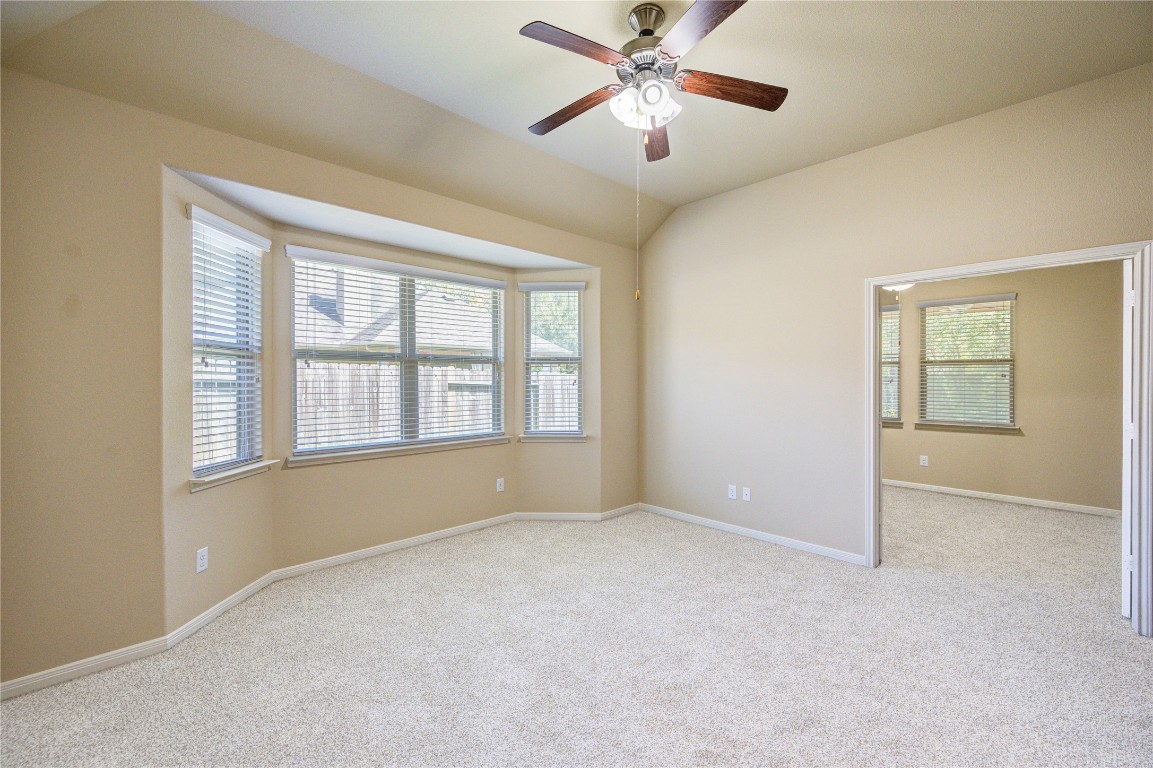 19306 Boulder Bay Lane Humble, TX 77346 - Photo 23 of 46 an empty room with chandelier fan and windows