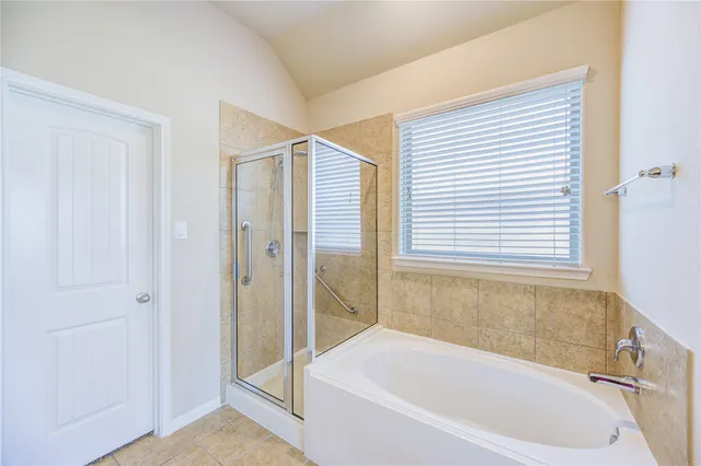a white bath tub sitting next to a shower