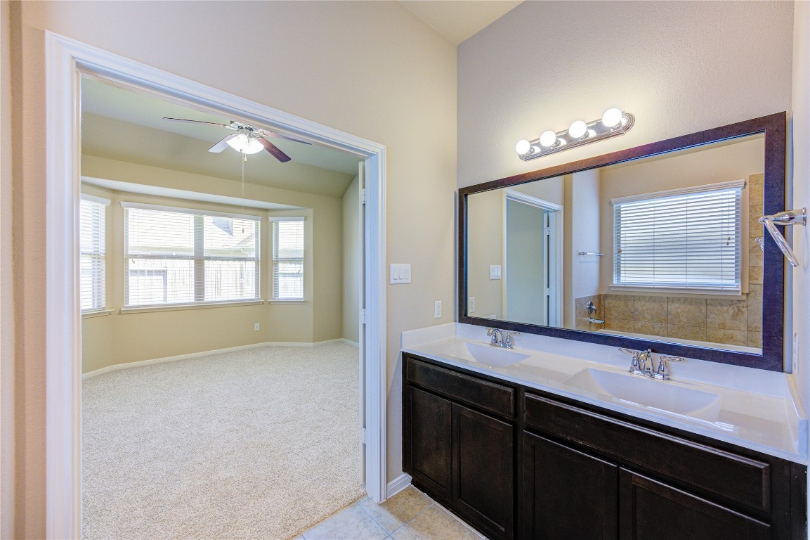 19306 Boulder Bay Lane Humble, TX 77346 - Photo 28 of 46 a en suite bathroom with a double vanity sink and a large mirror