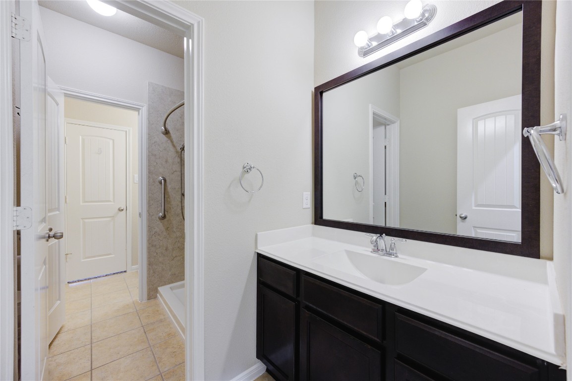 19306 Boulder Bay Lane Humble, TX 77346 - Photo 41 of 46 a bathroom with a sink and a mirror