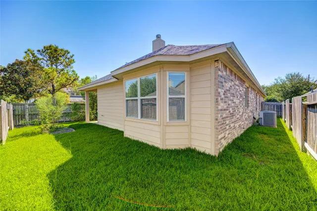 a view of a house with a backyard