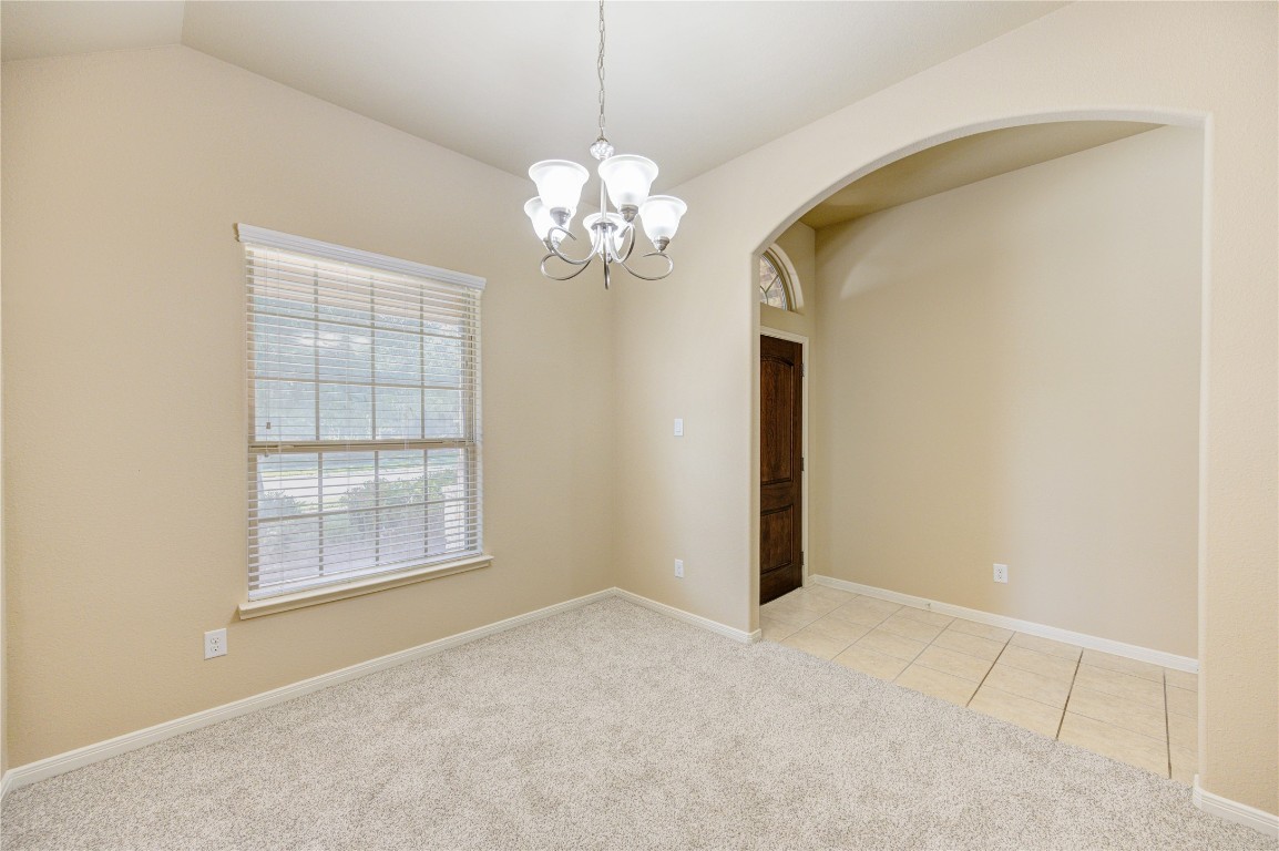 19306 Boulder Bay Lane Humble, TX 77346 - Photo 6 of 46 a view of an empty room with a chandelier