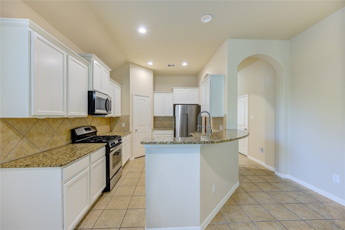 19306 Boulder Bay Lane Humble, TX 77346 - Photo 8 of 46 a kitchen with stainless steel appliances granite countertop a stove and a sink
