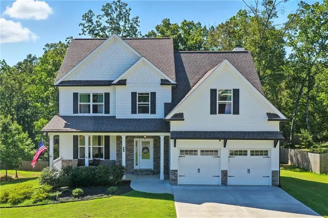 a view of house with yard and green space