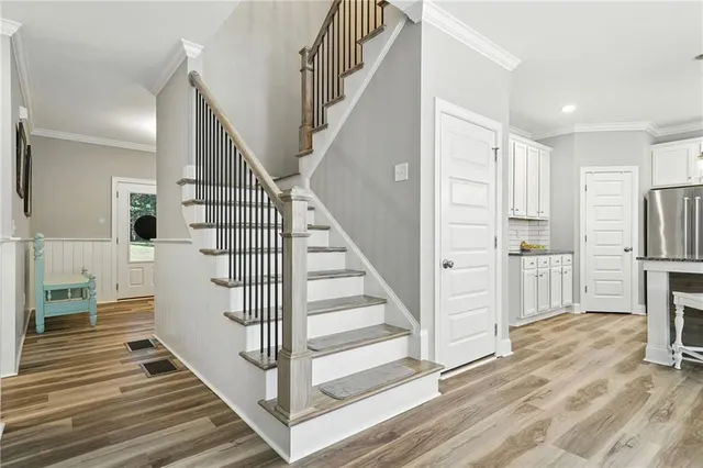 a view of entryway and hall with wooden floor