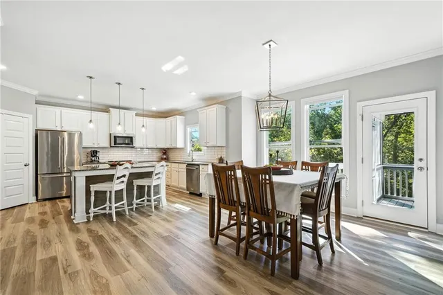 a view of a dining room with furniture window and wooden floor