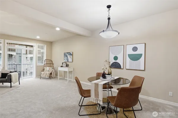 a dining room with furniture a chandelier and wooden floor