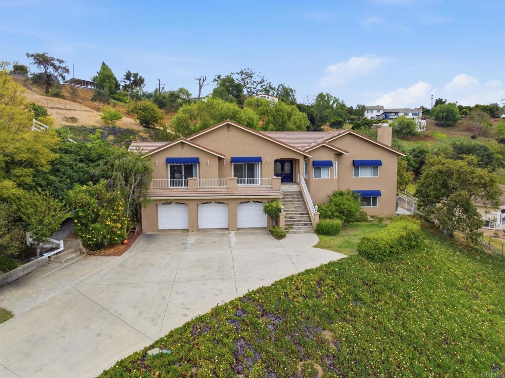 2596 Green Canyon Road Fallbrook, CA 92028 - Photo 1 of 74 a view of a house with a big yard and large trees