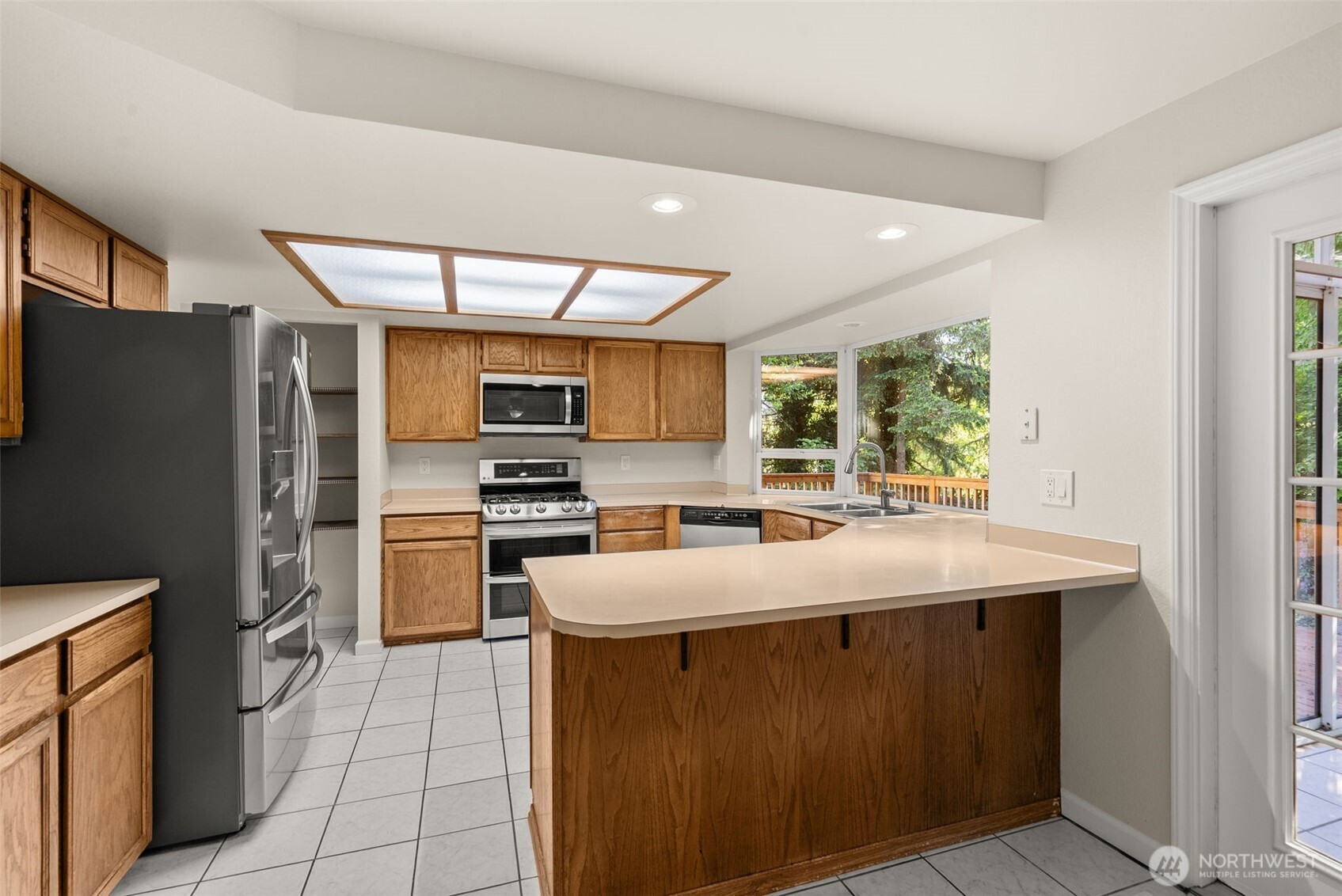 13603 Southeast 239th Street Kent, WA 98042 - Photo 5 of 23 a kitchen with stainless steel appliances granite countertop a refrigerator and a stove top oven