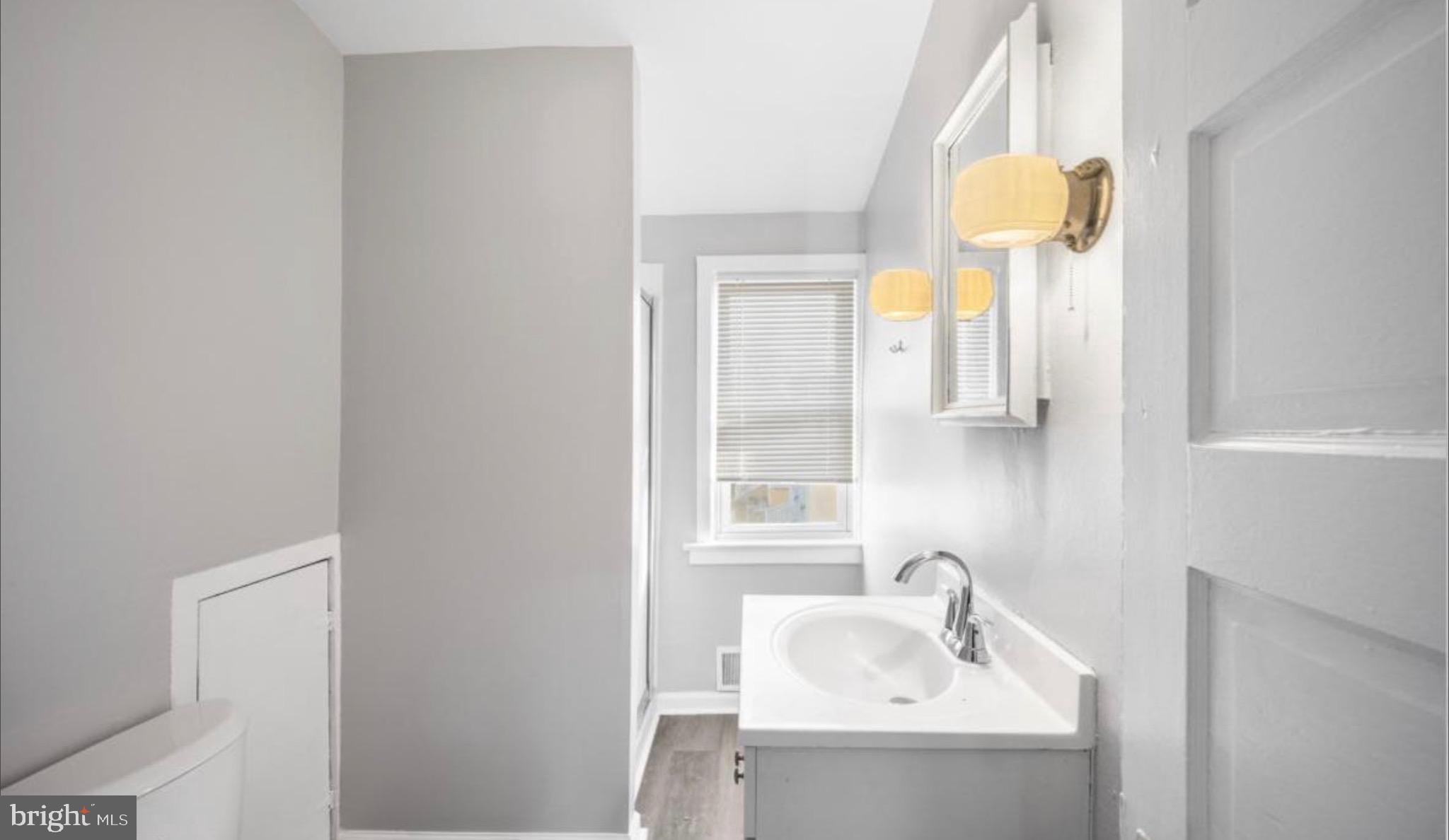124 Stiles Avenue Maple Shade, NJ 08052 - Photo 2 of 8 a bathroom with a sink and a mirror