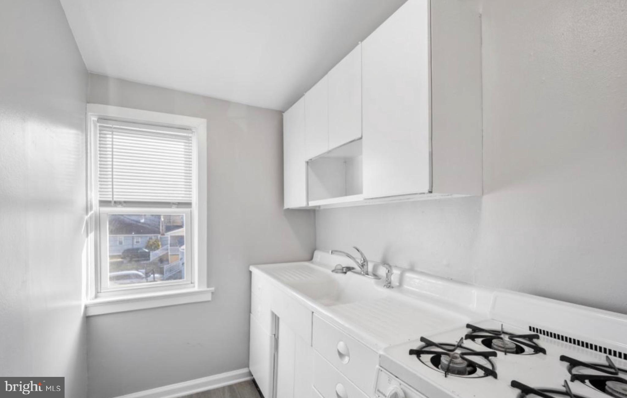 124 Stiles Avenue Maple Shade, NJ 08052 - Photo 3 of 8 a white kitchen with sink and window