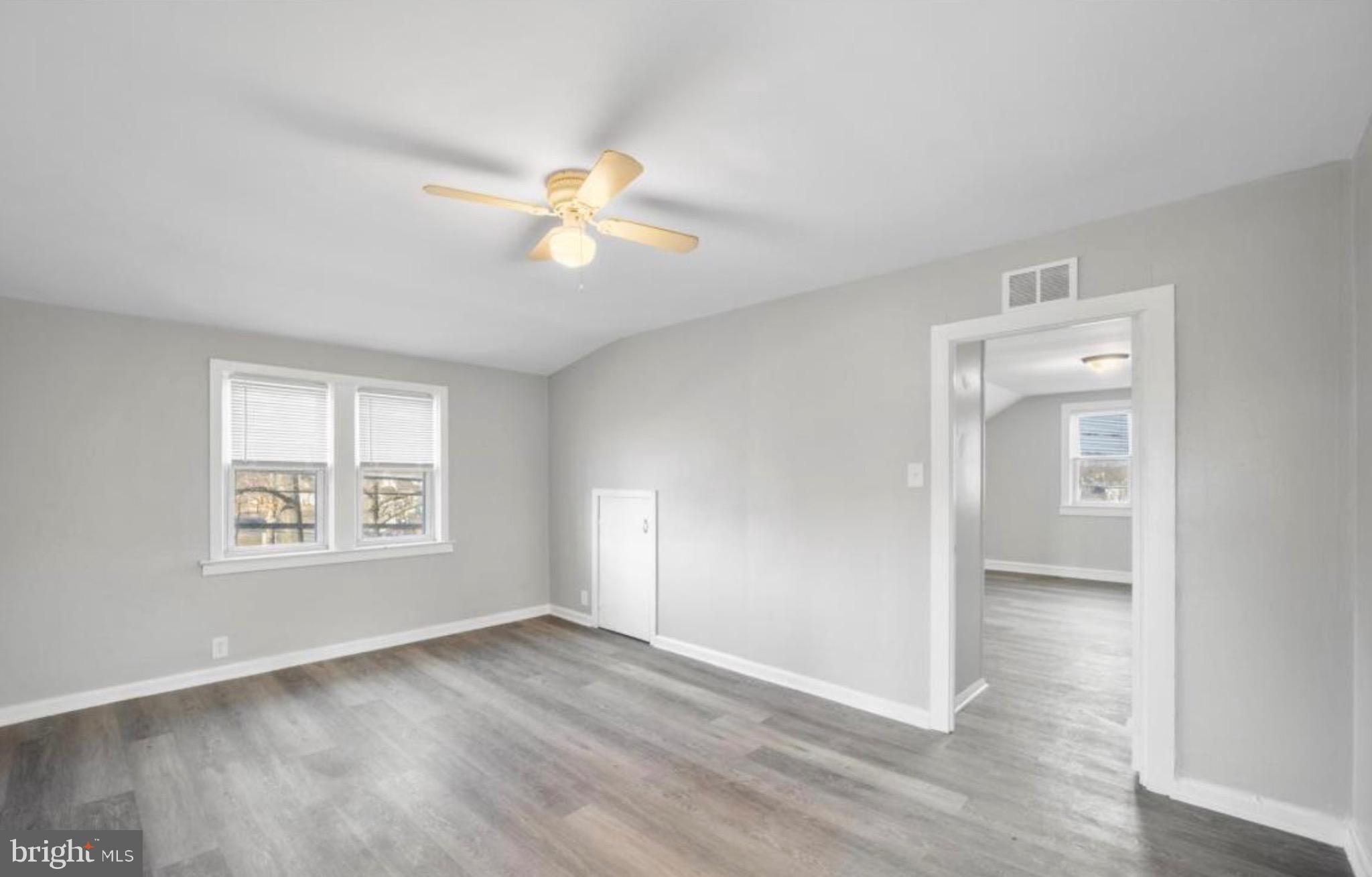 124 Stiles Avenue Maple Shade, NJ 08052 - Photo 4 of 8 a view of an empty room with a window and wooden floor