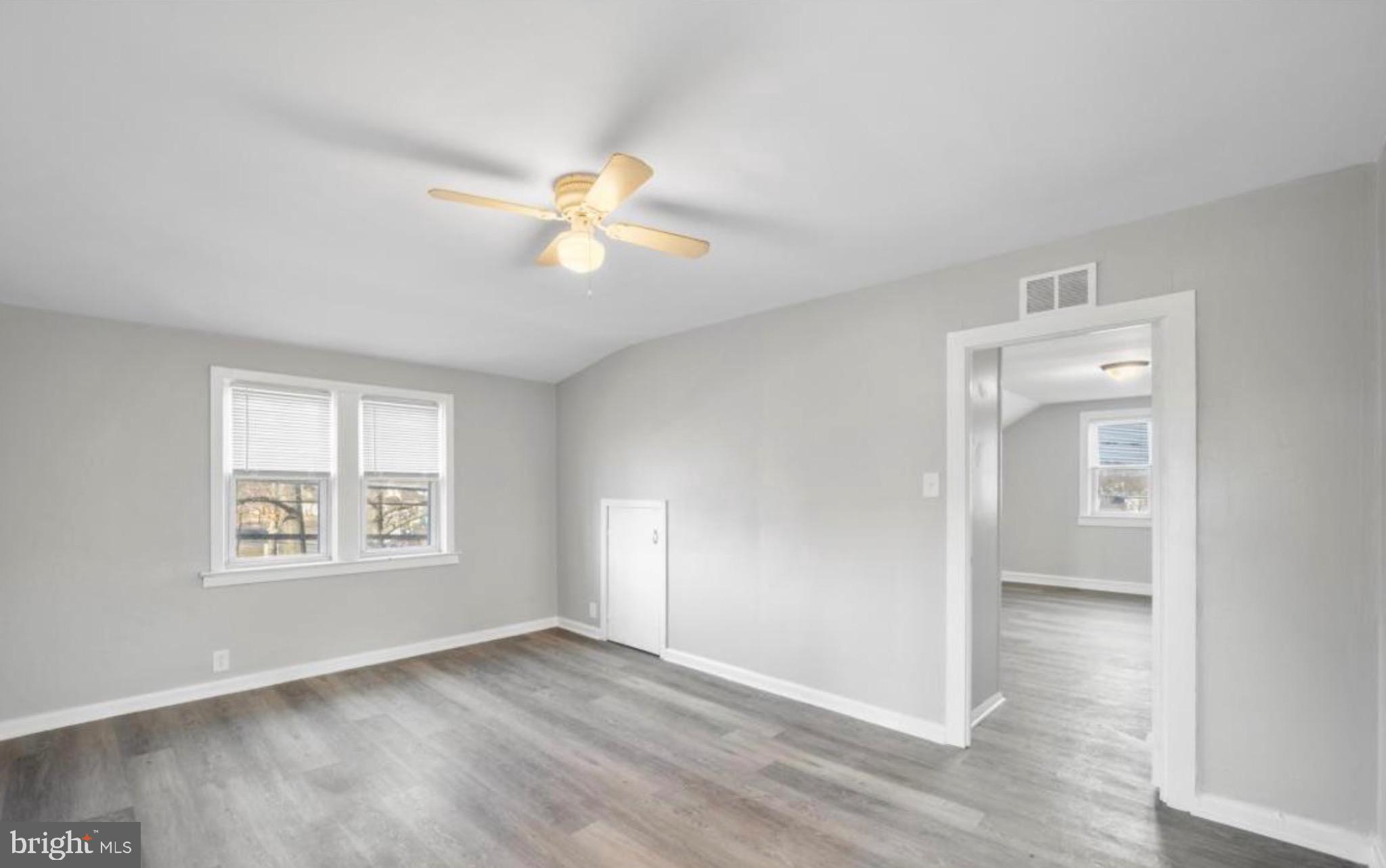 124 Stiles Avenue Maple Shade, NJ 08052 - Photo 7 of 8 an empty room with windows and a chandelier fan