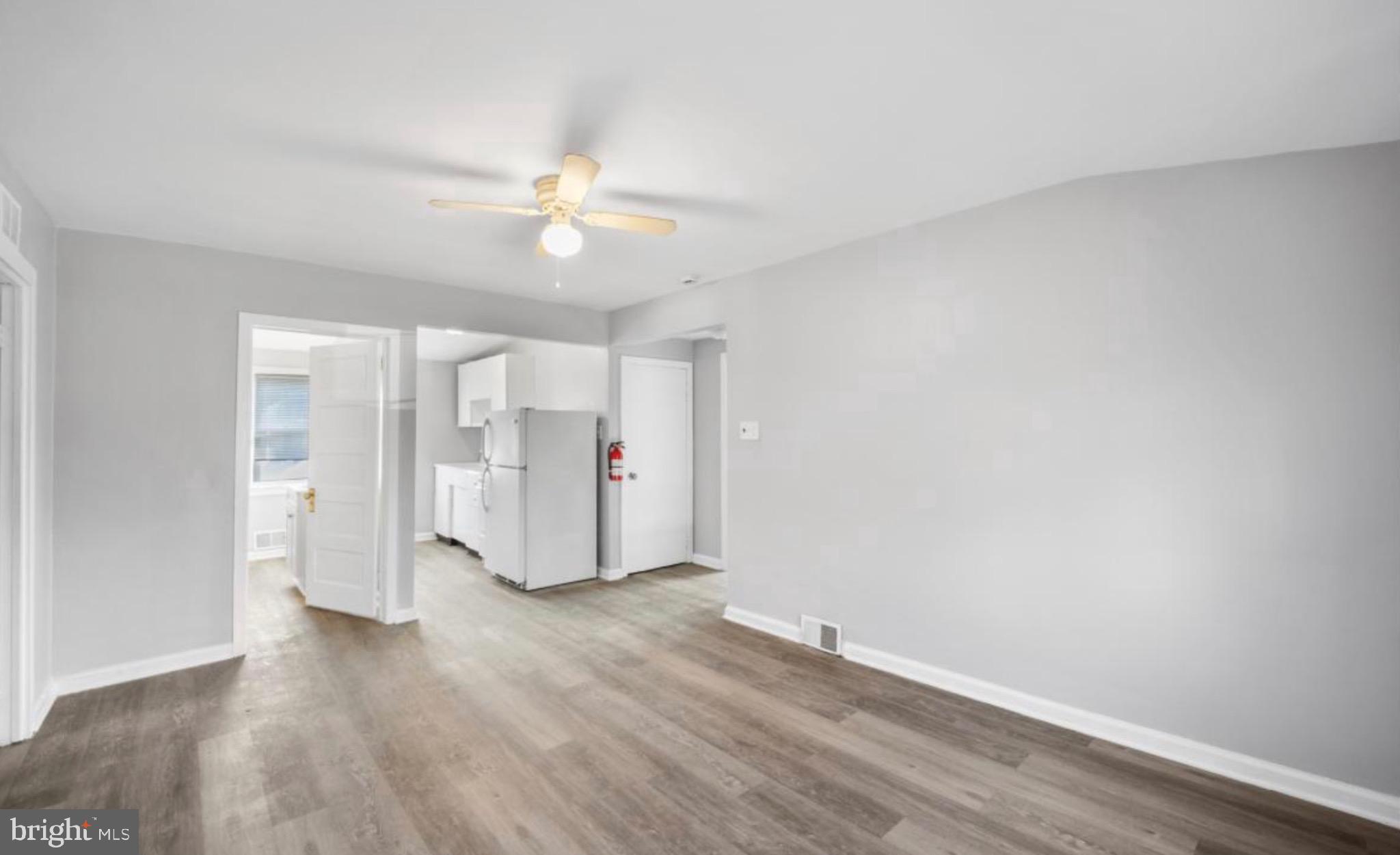 124 Stiles Avenue Maple Shade, NJ 08052 - Photo 8 of 8 an empty room with wooden floor and ceiling fan
