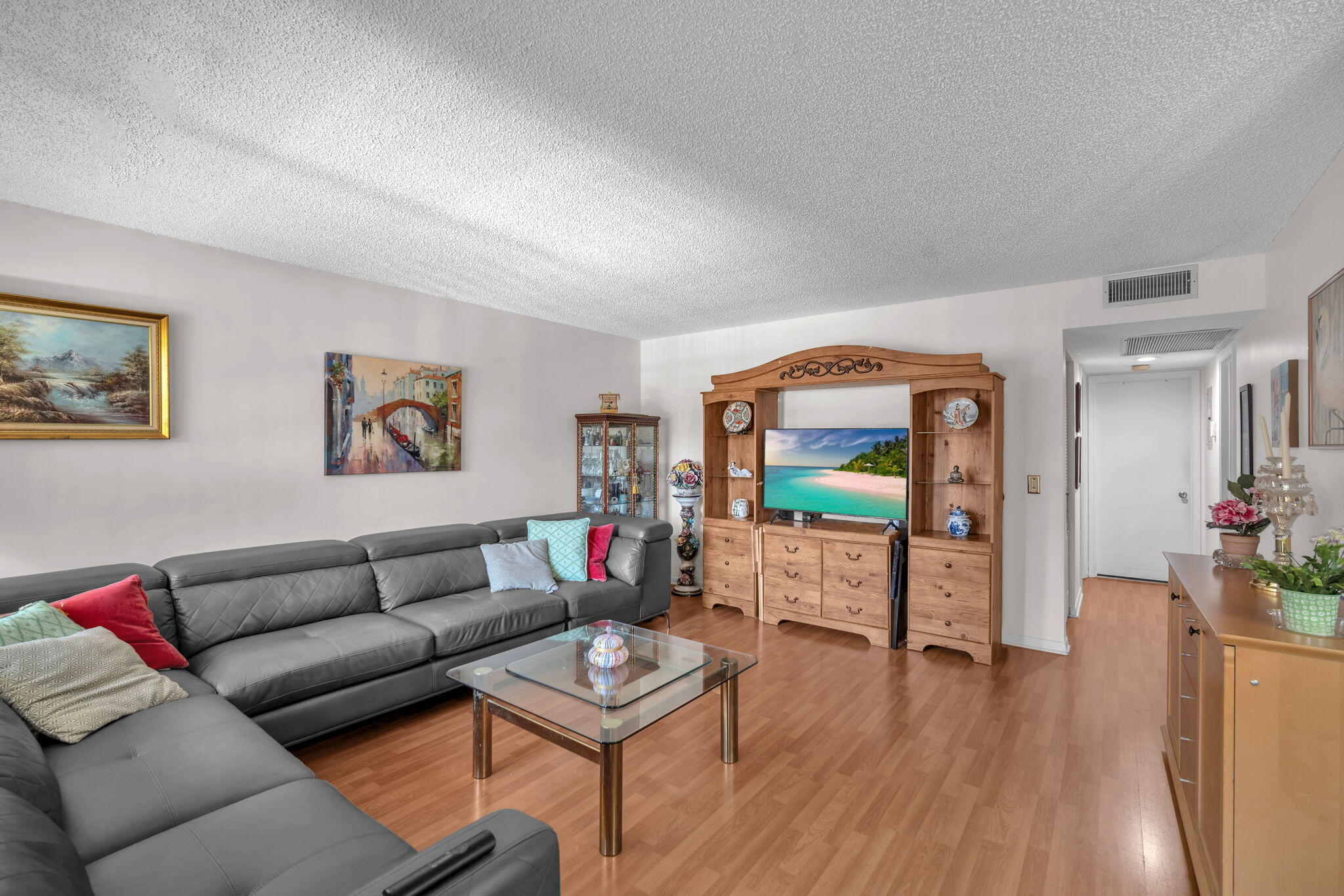 801 Southwest 133rd Terrace, Unit 317K Pembroke Pines, FL 33027 - Photo 2 of 13 a living room with furniture and a flat screen tv
