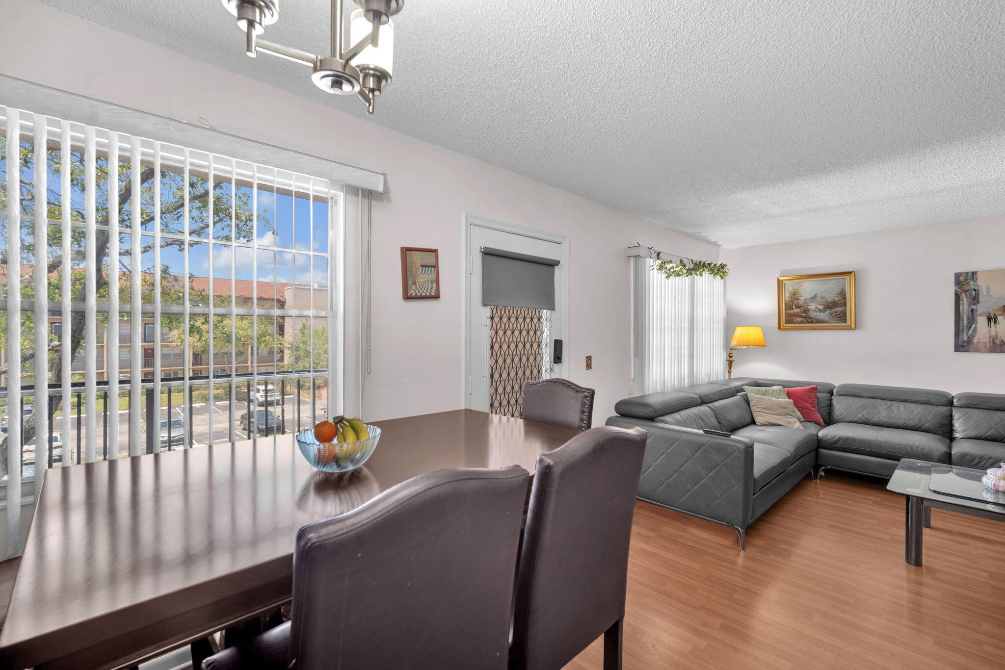 801 Southwest 133rd Terrace, Unit 317K Pembroke Pines, FL 33027 - Photo 3 of 13 a living room with furniture and a window