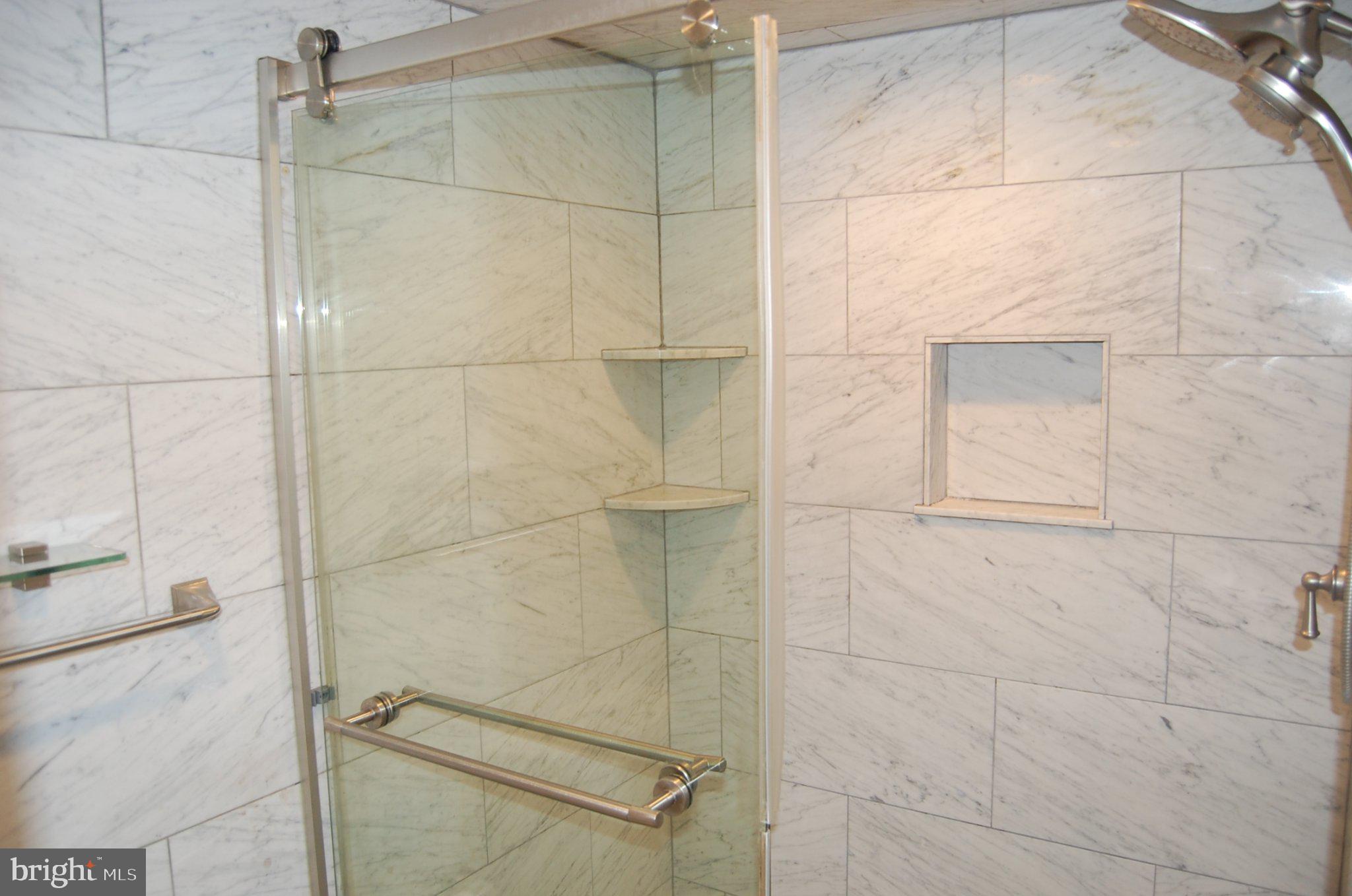 3346 Hewitt Avenue, Unit 11A Silver Spring, MD 20906 - Photo 5 of 8 Sleek glass shower with marble elegance.