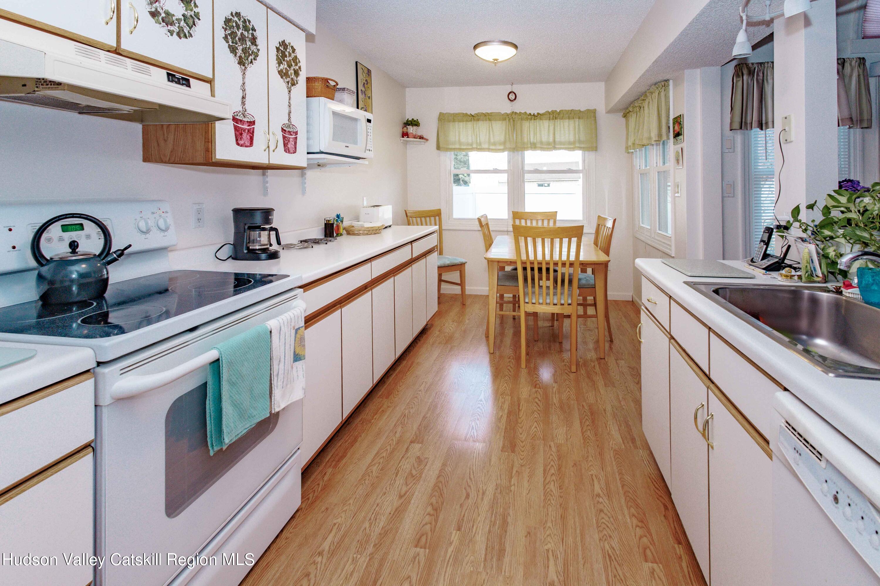 6 Red Maple Road Saugerties, NY 12477 - Photo 5 of 13 a kitchen with stainless steel appliances granite countertop a sink a stove and a wooden floors