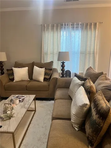 a living room with furniture and a lamp