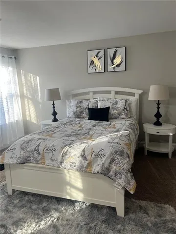 a bedroom with a bed and a couch