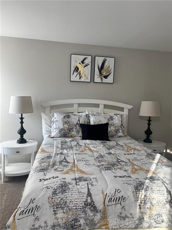 7150 Fringe Flower Drive, Unit 20 Austell, GA 30168 - Photo 25 of 41 a bedroom with a bed and a lamp on table