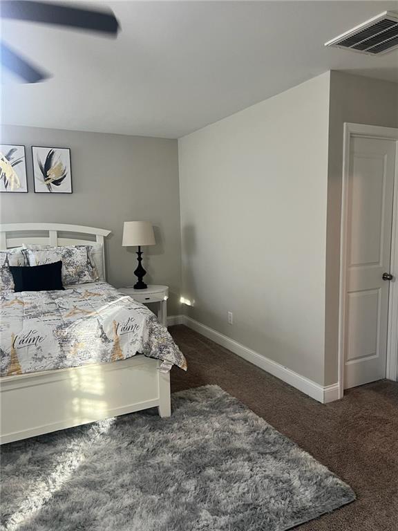 7150 Fringe Flower Drive, Unit 20 Austell, GA 30168 - Photo 27 of 41 a bedroom with a bed and wooden floor