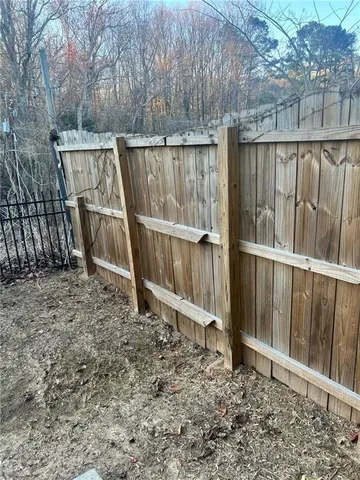 a view of outdoor space with wooden fence