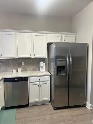 a kitchen with stainless steel appliances granite countertop a refrigerator and a sink