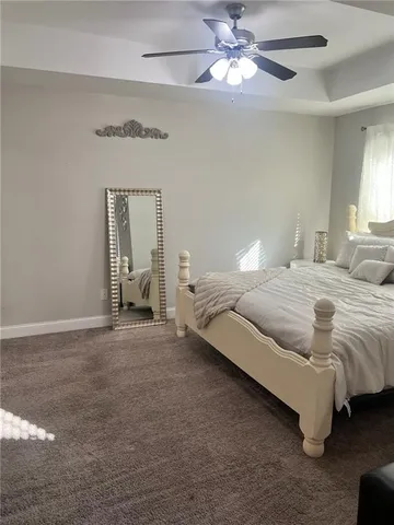 a spacious bedroom with a bed and a chandelier