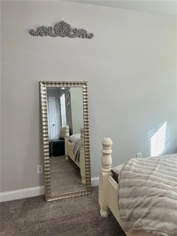 a bedroom with a bed and chair