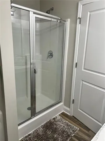a bathroom with a glass shower door
