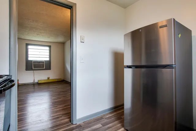 a view of a room with wooden floor and a window