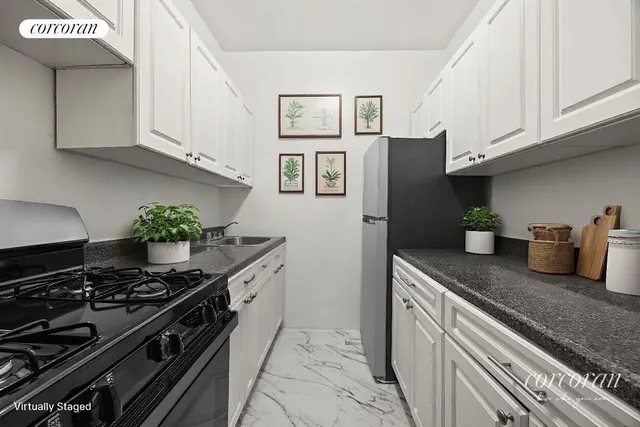 a bedroom with a bed a painting on the wall and a potted plant