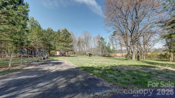 a view of a large yard with large trees
