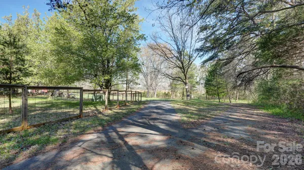 a view of a yard with wooden fence