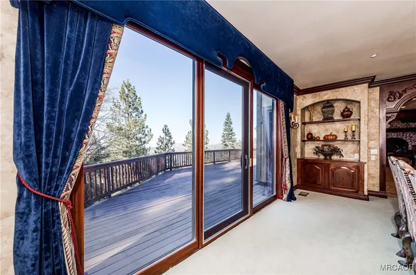 a view of a porch with wooden floor and furniture
