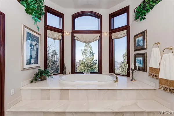 a large white kitchen with a large window