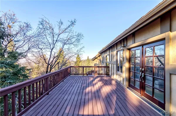 a view of balcony with wooden floor and fence