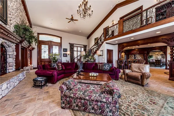 a living room with furniture ceiling fan and a rug