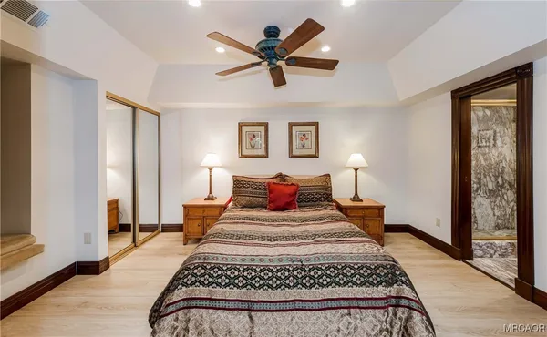 a bedroom with bed and a chandelier