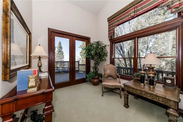 a living room with furniture and large windows