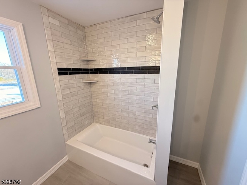 83 Academy Street Dover, NJ 07801 - Photo 11 of 14 a bathroom with a bathtub