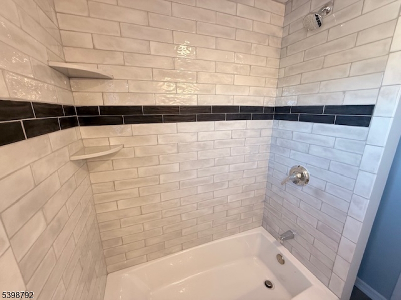 83 Academy Street Dover, NJ 07801 - Photo 12 of 14 a bathroom with a bathtub